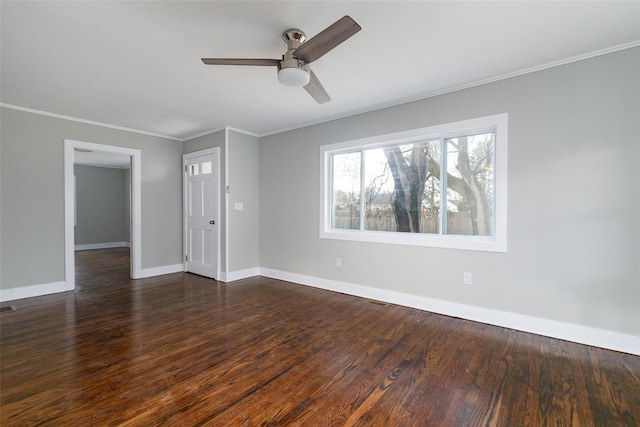 spare room featuring ceiling fan, crown molding, and dark wood-type flooring