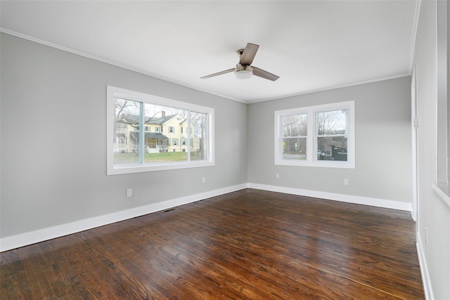 unfurnished room featuring dark wood-type flooring, a healthy amount of sunlight, and ornamental molding