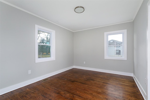 spare room with dark hardwood / wood-style floors and ornamental molding