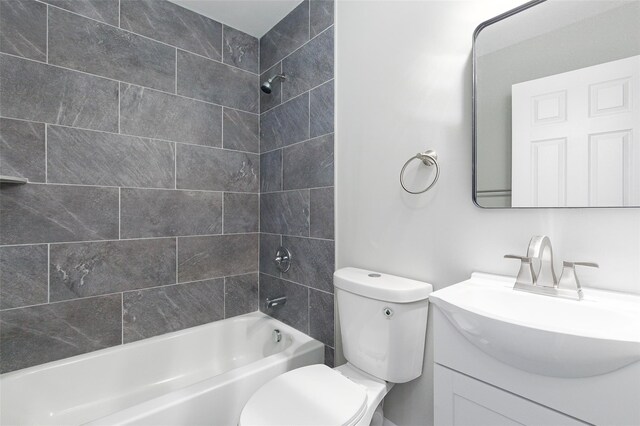 full bathroom with vanity, toilet, and tiled shower / bath