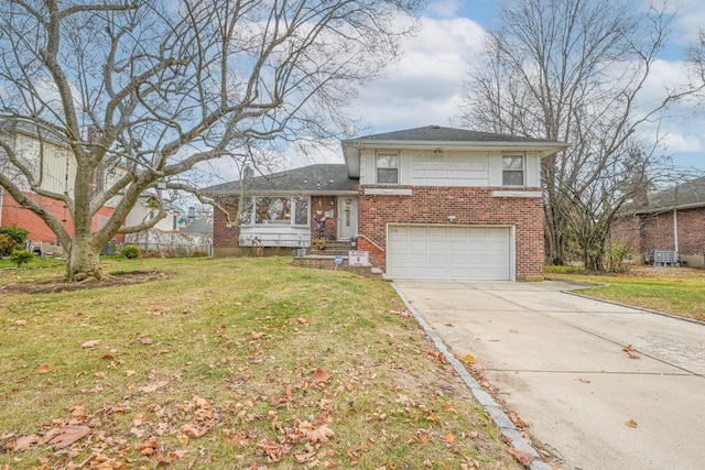 split level home featuring a garage and a front lawn