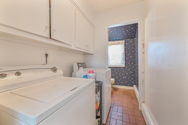 laundry area with a baseboard heating unit and washing machine and clothes dryer