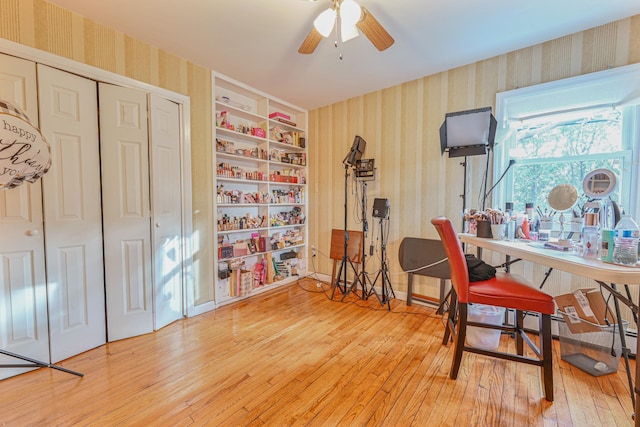 office space featuring ceiling fan, hardwood / wood-style floors, and built in features