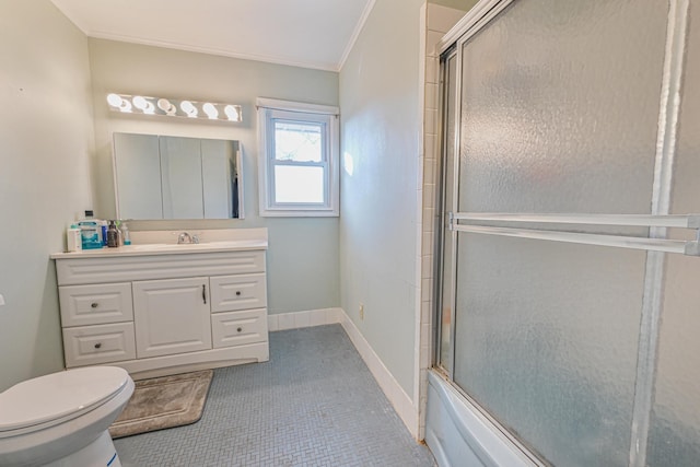 full bathroom with tile patterned floors, ornamental molding, vanity, enclosed tub / shower combo, and toilet