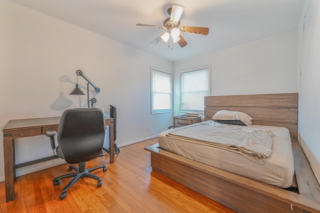 bedroom with ceiling fan and hardwood / wood-style floors