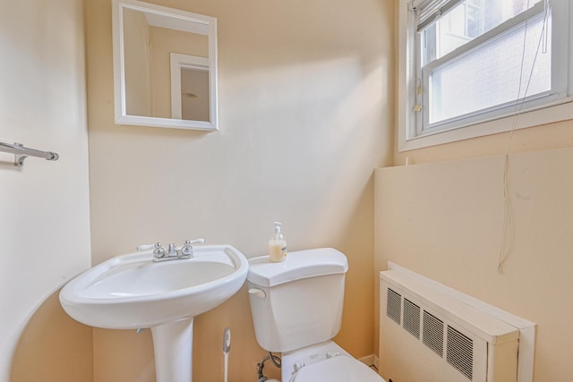 bathroom featuring radiator and toilet