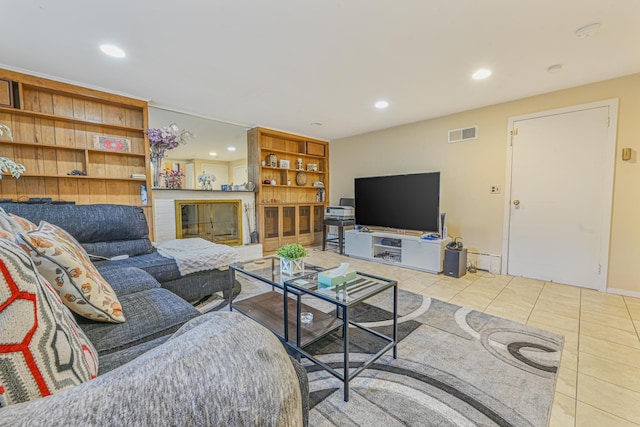 tiled living room featuring a fireplace