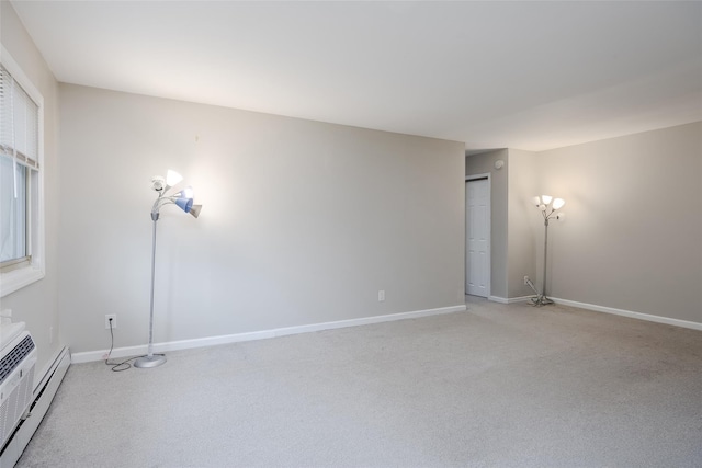 unfurnished room with light colored carpet and baseboard heating