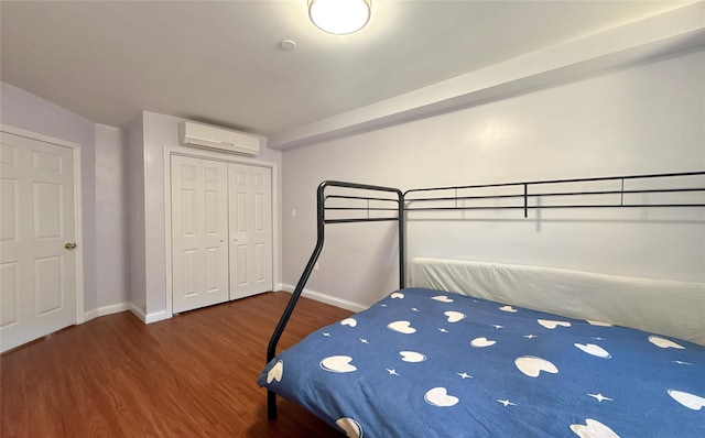 unfurnished bedroom with a wall mounted AC, dark hardwood / wood-style floors, and a closet