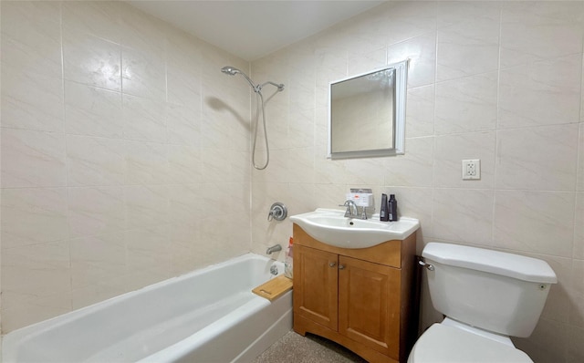 full bathroom with vanity, toilet, tile walls, and tiled shower / bath combo