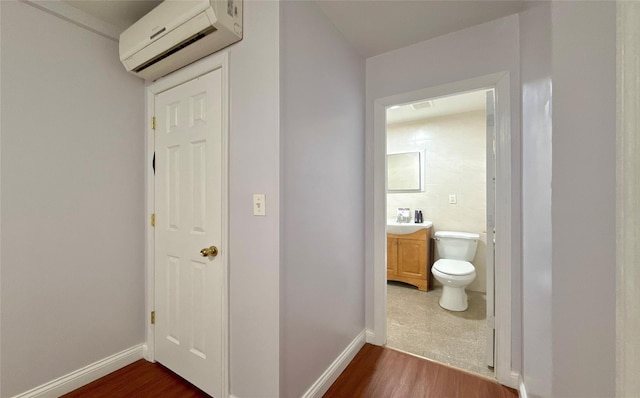 hall with dark hardwood / wood-style flooring and an AC wall unit