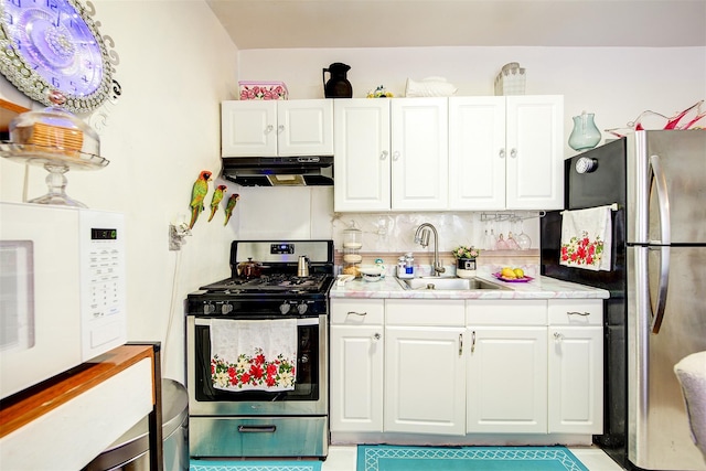 kitchen with white cabinetry, sink, appliances with stainless steel finishes, and tasteful backsplash