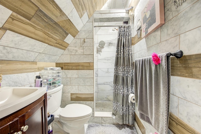 bathroom with vanity, toilet, tile walls, and curtained shower