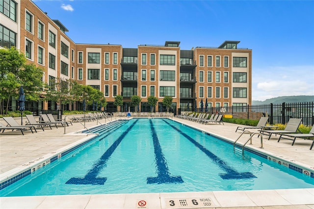 view of pool featuring a mountain view and a patio