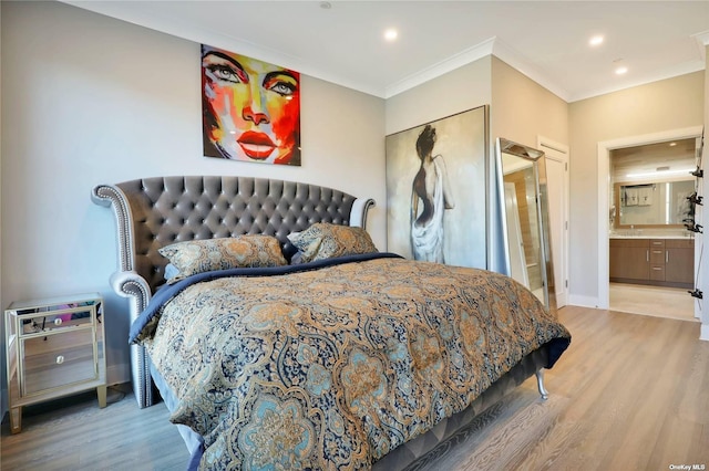 bedroom featuring ensuite bathroom, a closet, crown molding, and light hardwood / wood-style flooring