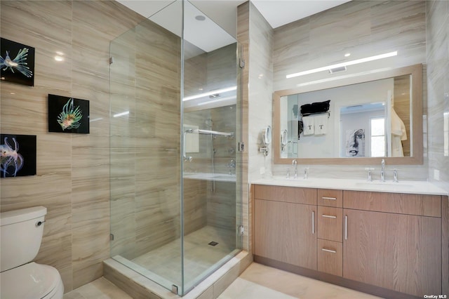 bathroom with walk in shower, tile patterned floors, tile walls, and toilet