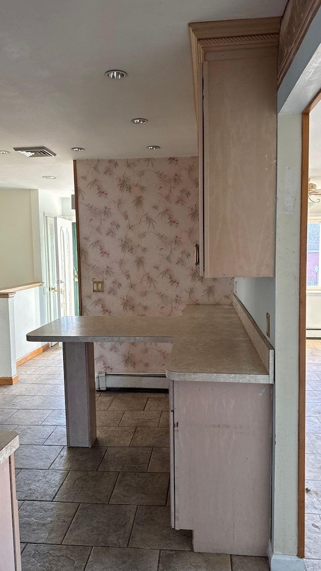 kitchen featuring a breakfast bar and a baseboard heating unit