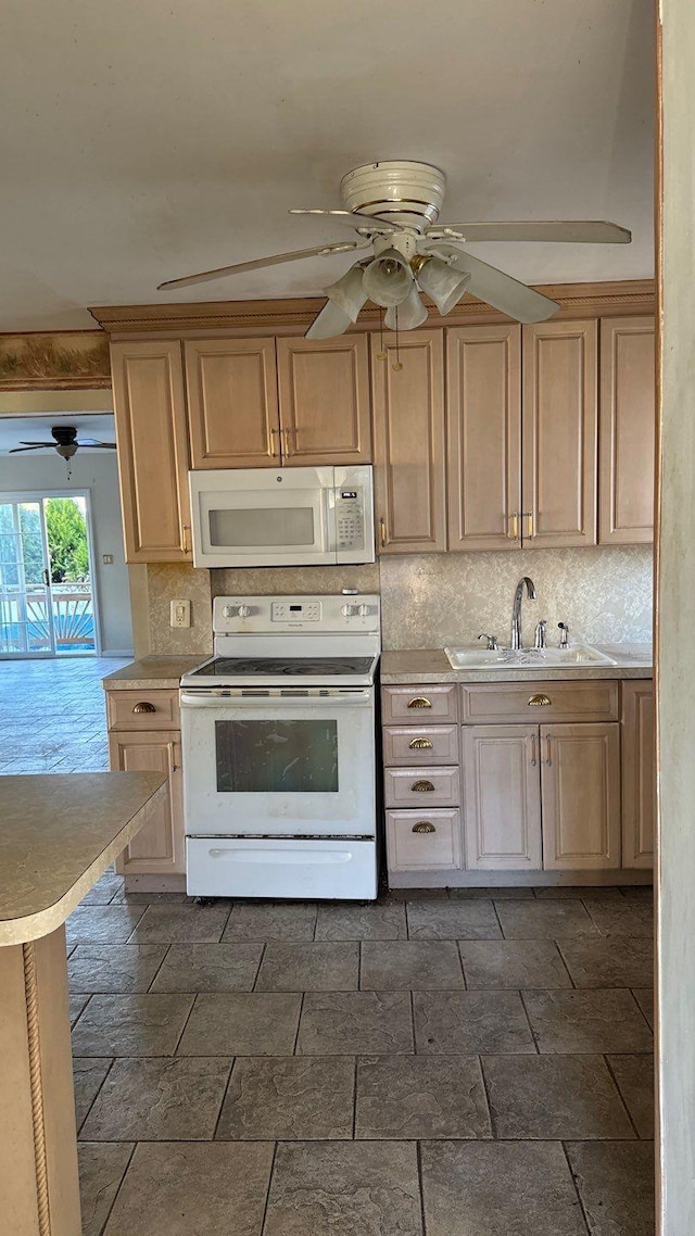 kitchen featuring decorative backsplash, sink, white appliances, and light brown cabinets