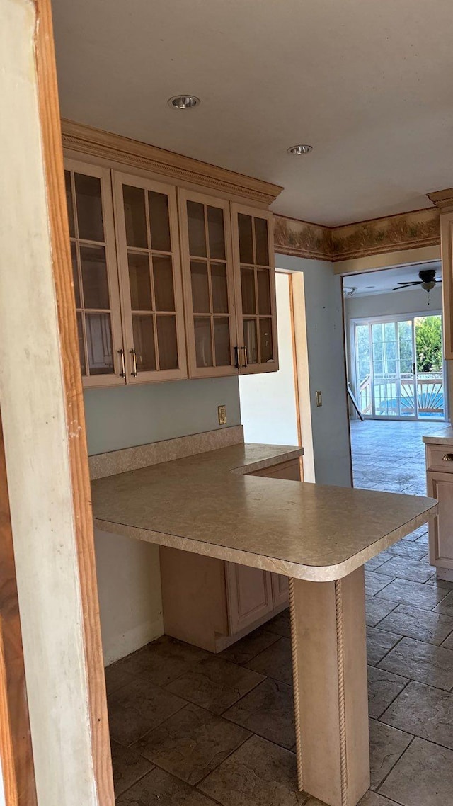 kitchen featuring a kitchen bar and kitchen peninsula