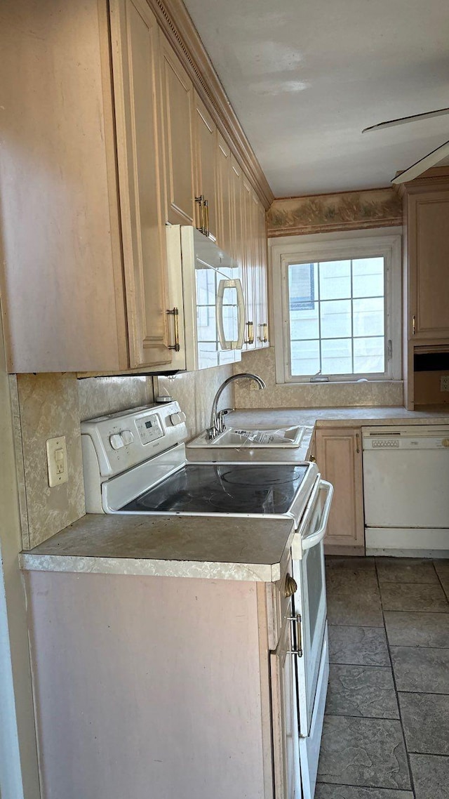 kitchen featuring decorative backsplash, light brown cabinets, white appliances, and sink