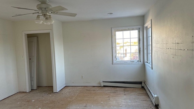 spare room featuring ceiling fan and a baseboard heating unit