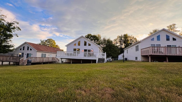 rear view of house with a yard and a deck