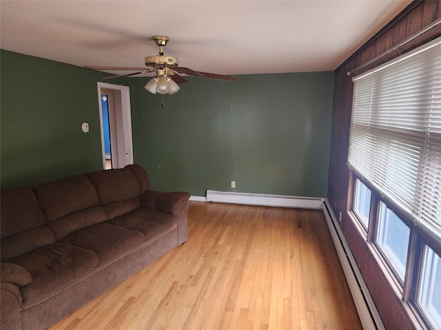 living room featuring a baseboard radiator, light hardwood / wood-style flooring, and ceiling fan