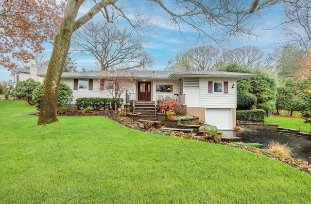 view of front of home with covered porch, a garage, and a front lawn