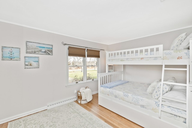 bedroom with wood-type flooring and baseboard heating