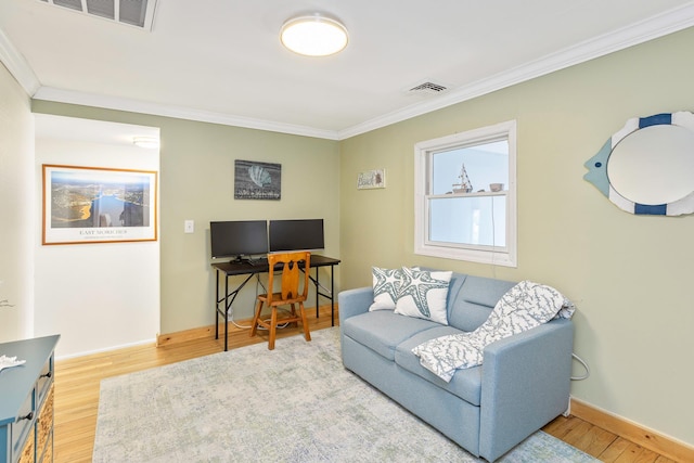 living area featuring crown molding and hardwood / wood-style floors