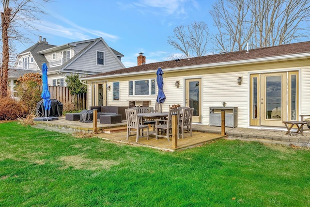 back of house featuring an outdoor hangout area, a deck, and a lawn