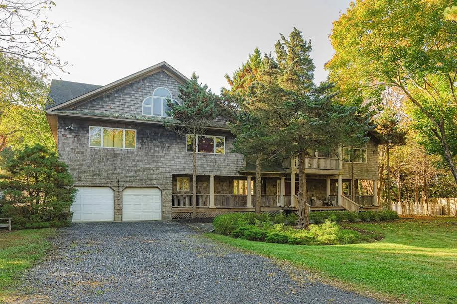 front facade with a front yard and a garage
