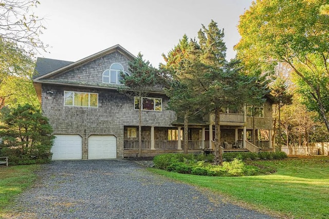 front facade with a front yard and a garage