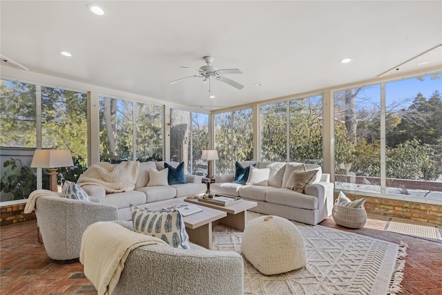 sunroom / solarium featuring ceiling fan