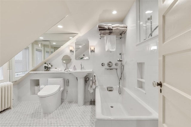 bathroom featuring tile patterned floors, radiator heating unit, toilet, and tile walls