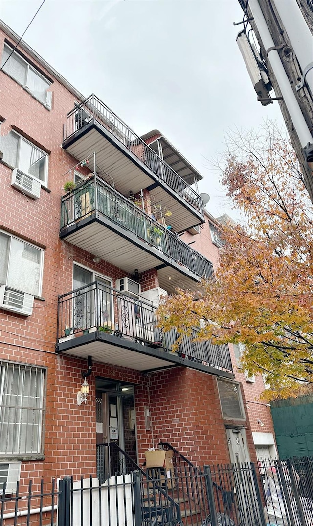 view of property with an AC wall unit