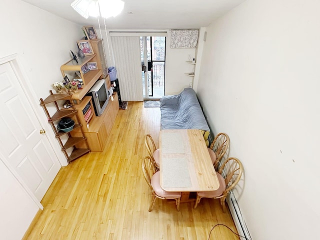 living area with hardwood / wood-style flooring and a baseboard radiator