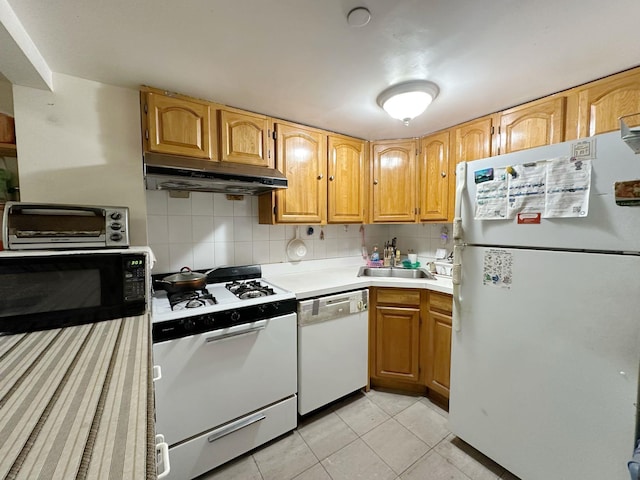 kitchen featuring decorative backsplash, sink, light tile patterned flooring, and white appliances