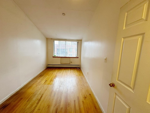 spare room featuring light hardwood / wood-style flooring and baseboard heating