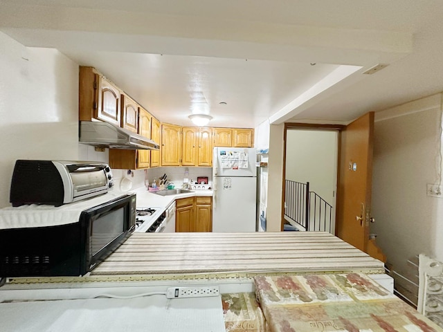 kitchen featuring kitchen peninsula, white appliances, and sink