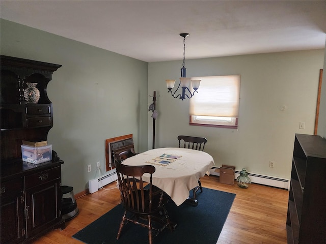 dining room featuring light hardwood / wood-style floors, baseboard heating, and a notable chandelier