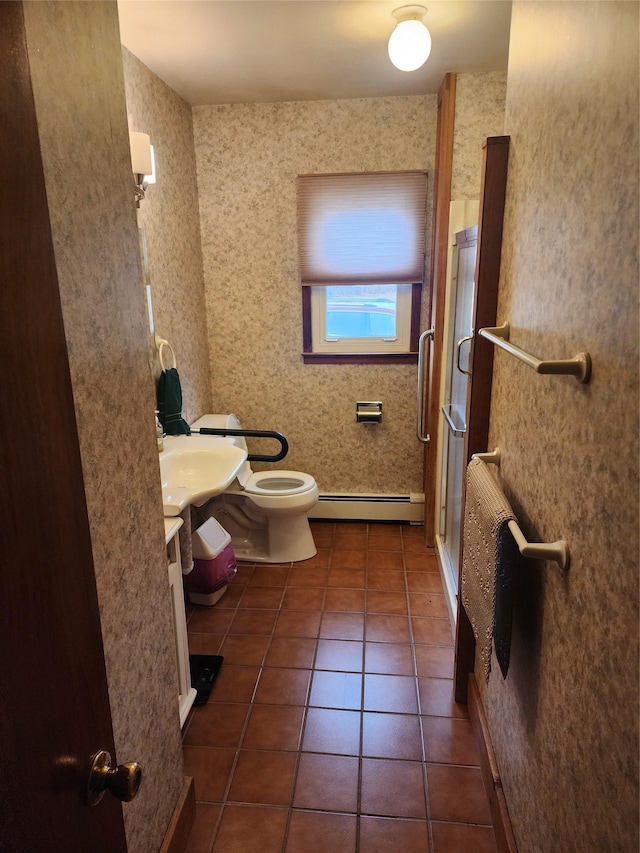 bathroom with an enclosed shower, vanity, a baseboard heating unit, tile patterned flooring, and toilet