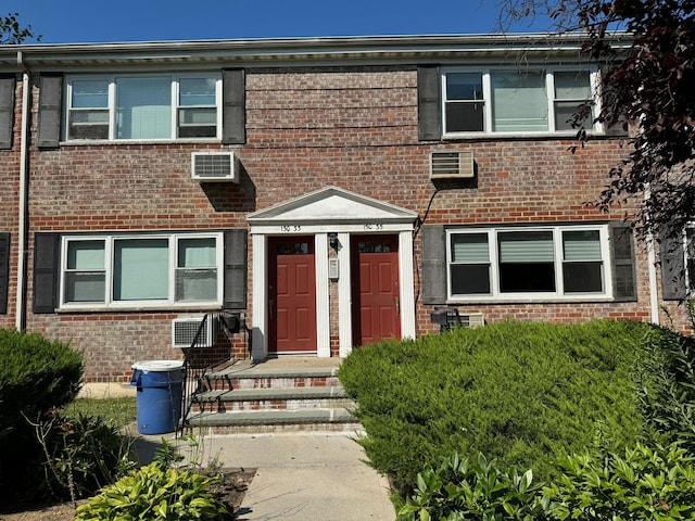 view of front of house with a wall mounted AC