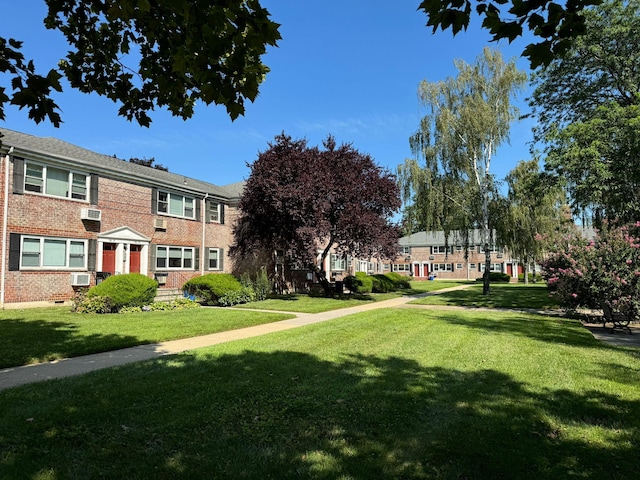 view of property's community featuring a yard