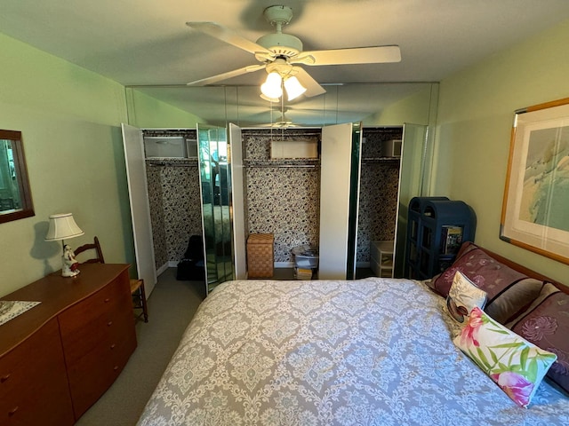 carpeted bedroom featuring multiple closets and ceiling fan