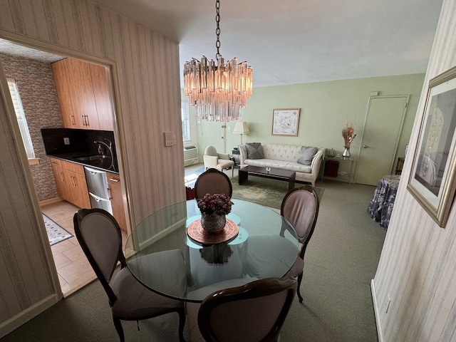 dining space with sink and a notable chandelier