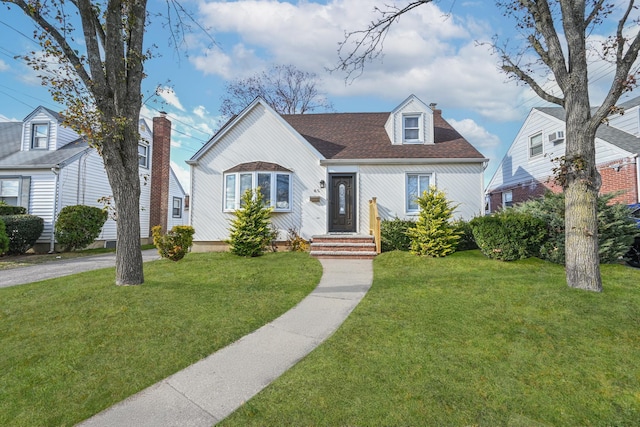 cape cod house featuring a front lawn