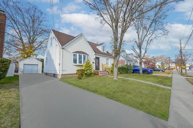 view of front of home featuring an outbuilding, a front lawn, and a garage