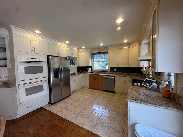 kitchen with a sink, stainless steel appliances, recessed lighting, and light tile patterned floors