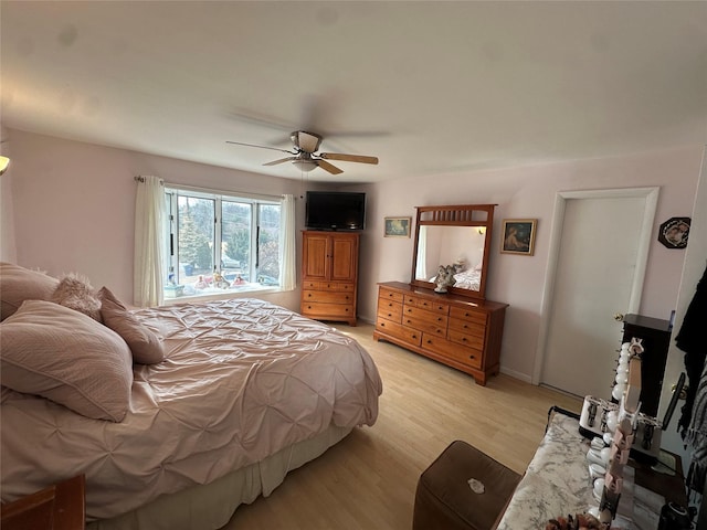 bedroom with light wood-type flooring and a ceiling fan